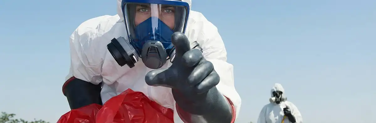 sewage clean up technician wearing protective gear handling biohazard materials in Savannah, GA