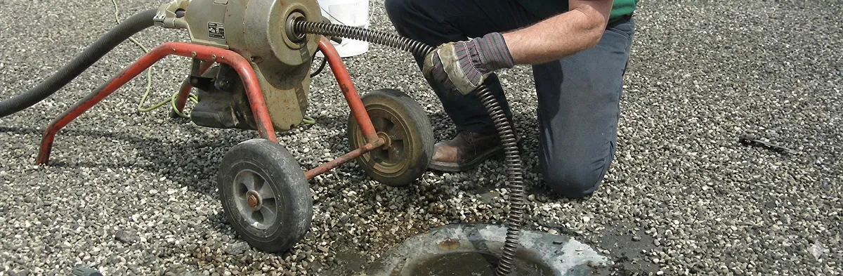 sewer rodding technician actively removing blockages from a sewer line in Savannah, GA