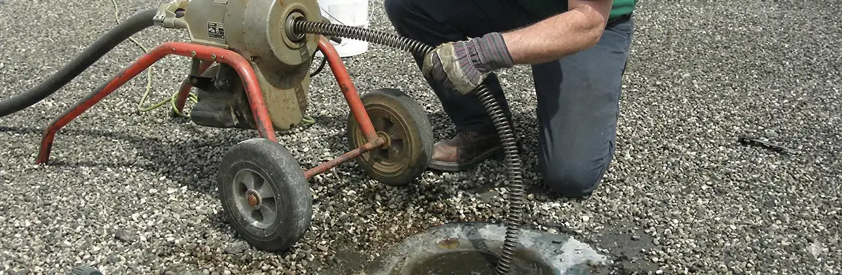 sewer rodding technician actively removing blockages from a sewer line in Savannah, GA